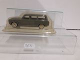 a toy car in a clear case on a table