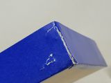 a blue box with a hole in it sitting on a table