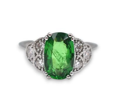 a close up of a green tourmaline and diamond ring
