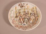 a plate with a picture of a group of people on it