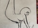 drawing of an ostrich on a piece of paper next to a pencil