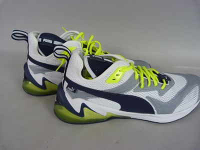 a close up of a pair of shoes with yellow laces