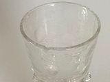 a glass cup that is sitting on a table