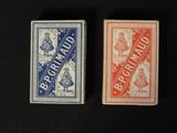 two playing cards sitting next to each other on a black surface
