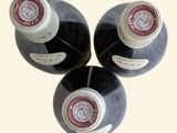 three bottles of wine sitting next to each other on a table