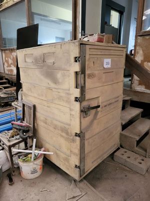 a wooden box that is sitting in the middle of a room