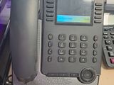 a telephone that is sitting on a desk next to a keyboard