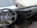 dashboard of a truck with a steering wheel and dashboard controls