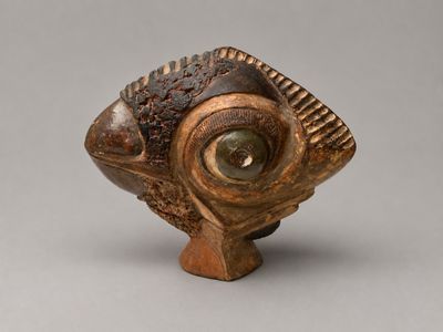 a close up of a wooden object with a fish on it