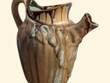 a brown vase with a handle on a white background