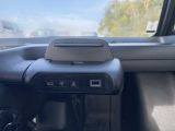 a car dashboard with a steering wheel and a cell phone in it