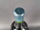 a close up of a bottle of wine on a table