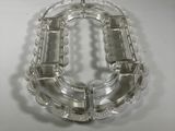 a clear glass bracelet that is sitting on a table