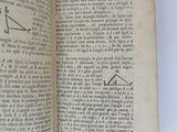 someone is holding a book with a drawing of a triangle on it