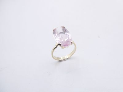a pink stone ring on a white surface