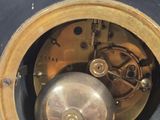 a clock that is sitting in a hole in the wall