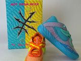 pair of colorful shoes sitting next to a box on a white surface