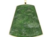 a close up of a green pendant on a white background