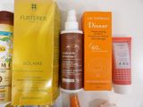 many sunscreens and sunscreen creams on the table
