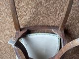 a bucket with two wooden handles on a carpeted floor