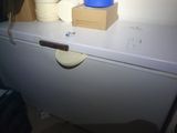 a blue bowl sitting on top of a white refrigerator