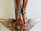 a statue of a bird with wings on it ' s head