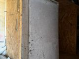 a white refrigerator sitting in the corner of a room