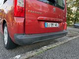 a red van that is parked on the side of the road