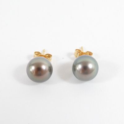 a pair of black pearl earrings on a white background