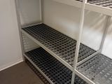 a metal shelf with two shelves on it in a room