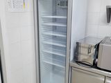 a refrigerator that is open in a kitchen with a microwave on the counter