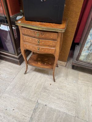 a television sitting on top of a small wooden table