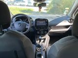 the interior of a small car with a steering wheel and dashboard