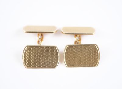 a pair of gold cufflinks on a white background