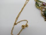 collier plaqué or avec un pendentif en forme de feuille verte et une perle en verre violette