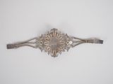 an antique silver plated hair clip with a flower design
