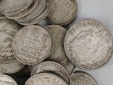 a pile of silver coins sitting on a table