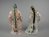 pair of porcelain figurines of a man and a woman