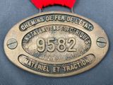 medal with red ribbon on blue cloth with red ribbon around it