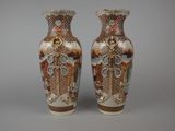 two vases sitting side by side on a gray surface