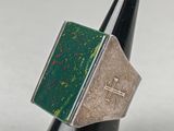 a close up of a ring with a cross on it