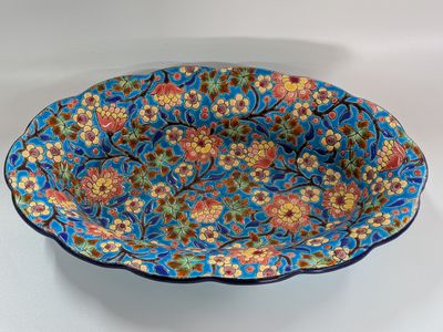 a close up of a blue bowl with flowers on it