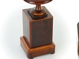 a small table with a wooden base and a small bowl on top of it
