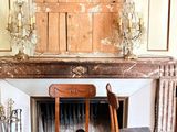 two chairs sitting in front of a fireplace in a living room