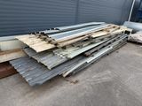 a pile of metal sheets sitting on top of a cement floor