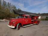 a red fire truck that is parked in a lot
