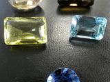 a close up of three different colored gems on a table