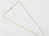 a gold necklace with a triangle shaped pendant on a white background