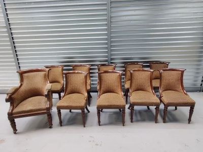 six chairs in a row in front of a garage door