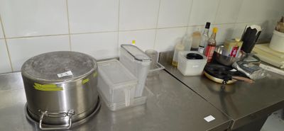 stainless steel counter top with a pot on top of it in a kitchen